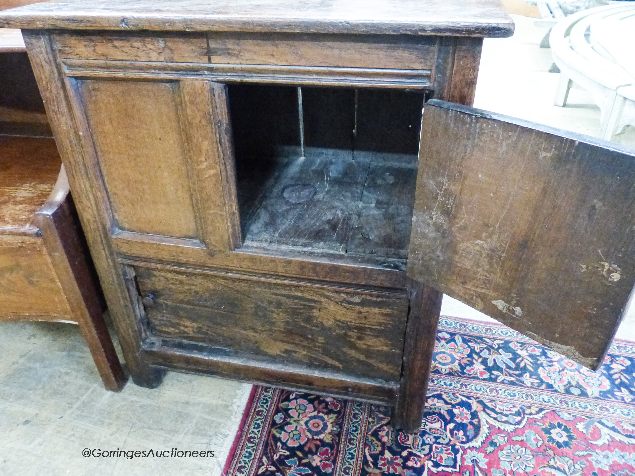 A 17th century oak low cupboard of rectangular form